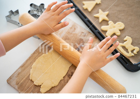 Children's hands making cookies Children's hands making cookies 84467231