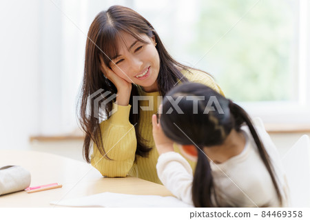 Girl and mom studying 84469358