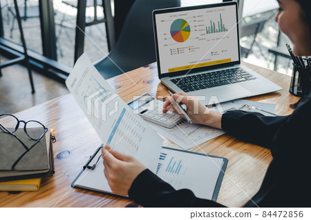 Business woman using calculator for analysis maketing plan, Accountant calculate financial report, computer with graph chart. Business, Finance and Accounting concept Business woman using calculator for analysis maketing plan, Accountant calculate financial report, computer with graph chart. Business, Finance and Accounting concept 84472856