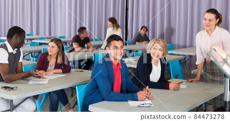 Adult students discussing lesson Adult students discussing lesson 84473278