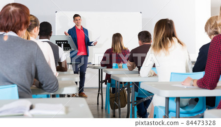 Male teacher lecturing to students Male teacher lecturing to students 84473328