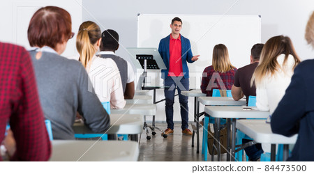 Male teacher lecturing to students Male teacher lecturing to students 84473500