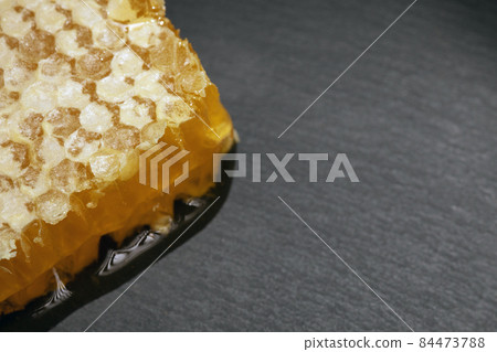 sweet organic honey on grey background sweet organic honey on grey background 84473788