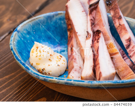 Close-up of sliced roasted squid and topping mayonnaise. 84474039