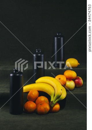 Still life with black bottles and fruits Still life with black bottles and fruits 84474763