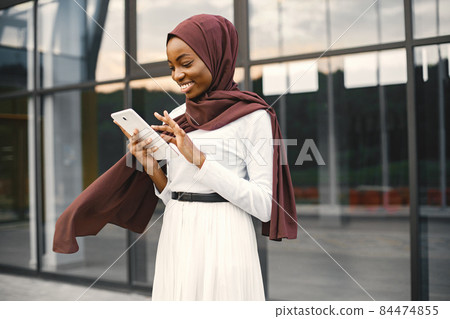 Portrait of young muslim woman wearing hijab using a tablet Portrait of young muslim woman wearing hijab using a tablet 84474855