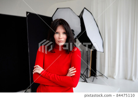 Female folding hands in studio with photo equipment Female folding hands in studio with photo equipment 84475110