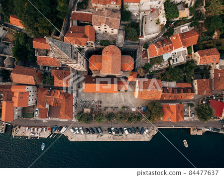 Top view of the bell tower among the old houses in Perast. Montenegro 84477637
