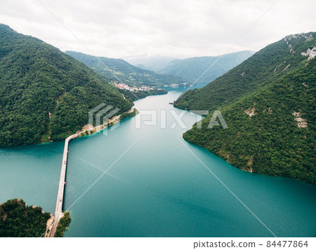 Blue water of Lake Piva at the bottom of the canyon. Montenegro Blue water of Lake Piva at the bottom of the canyon. Montenegro 84477864