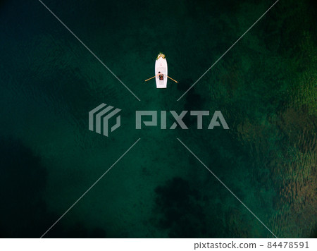Couple is sailing on a boat on the sea. Aerial view 84478591