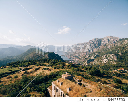Bride and groom stand on the top of the Gorazda fort on Mount Lovcen. Drone Bride and groom stand on the top of the Gorazda fort on Mount Lovcen. Drone 84478760