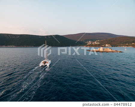 Yacht is sailing to the island of Otocic Gospa. Montenegro Yacht is sailing to the island of Otocic Gospa. Montenegro 84478912