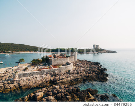 Castle on the island of Otocic Gospa. Montenegro. Drone 84479296