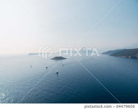 Sailboats sail along the Kotor Bay to the island of Mamula. Montenegro Sailboats sail along the Kotor Bay to the island of Mamula. Montenegro 84479608