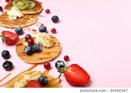 Concept of delicious dessert with pancakes on pink background 84480367