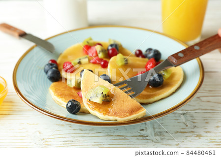 Concept of delicious dessert with pancakes on white wooden table 84480461