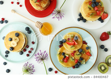 Concept of delicious dessert with pancakes on white background 84480487