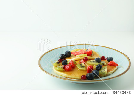 Concept of delicious dessert with pancakes on white background Concept of delicious dessert with pancakes on white background 84480488