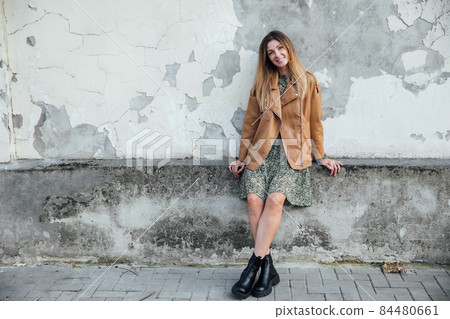 beautiful woman in dress and jacket walks around the autumn city beautiful woman in dress and jacket walks around the autumn city 84480661