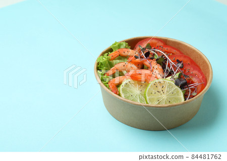Concept of tasty eating with shrimp salad on blue background 84481762