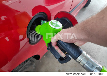 Filling up car's gas tank Filling up car's gas tank 84481808