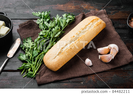 Ingredients for sandwich with butter, herbs and baguette, on old dark wooden table background Ingredients for sandwich with butter, herbs and baguette, on old dark wooden table background 84482211
