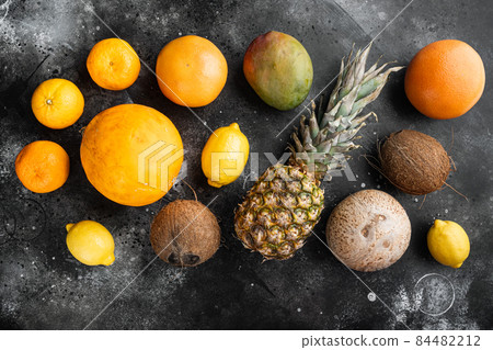 Fresh tropical fruit, on black dark stone table background, top view flat lay Fresh tropical fruit, on black dark stone table background, top view flat lay 84482212