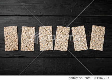 Set of crispy breads, on black wooden table background, top view flat lay, with copy space for text Set of crispy breads, on black wooden table background, top view flat lay, with copy space for text 84482293
