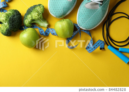 Healthy lifestyle accessories on yellow background, space for text Healthy lifestyle accessories on yellow background, space for text 84482828