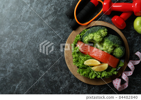 Healthy lifestyle accessories on black smokey table 84482840