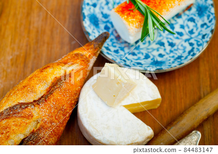 French cheese and fresh  baguette on a wood cutter 84483147