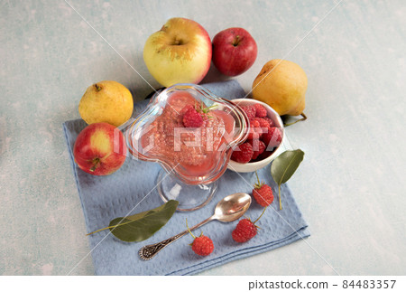Top view of a smoothie made of seasonal fruits - apples, raspberry pears on a light table. Top view of a smoothie made of seasonal fruits - apples, raspberry pears on a light table. 84483357