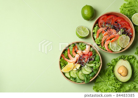 Tasty shrimp salad on green background, space for text Tasty shrimp salad on green background, space for text 84483385