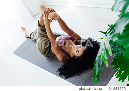 beautiful woman doing yoga asana gymnastics at home beautiful woman doing yoga asana gymnastics at home 84483833