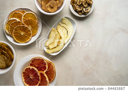 Homemade organic dried fruit slices in plates, top view. Dried orange, grapefruit, pineapples, copy space Homemade organic dried fruit slices in plates, top view. Dried orange, grapefruit, pineapples, copy space 84483887