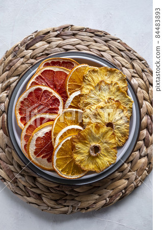 Homemade organic dried fruit slices. Dried orange, grapefruit, pineapples in a platel. Healthy snack or dessert. Homemade organic dried fruit slices. Dried orange, grapefruit, pineapples in a platel. Healthy snack or dessert. 84483893