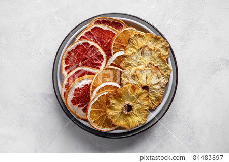 Homemade organic dried fruit slices. Dried orange, grapefruit, pineapples in a platel. Healthy snack or dessert. Homemade organic dried fruit slices. Dried orange, grapefruit, pineapples in a platel. Healthy snack or dessert. 84483897
