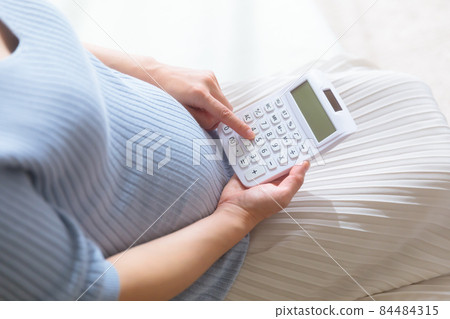 Pregnant female calculated with a calculator Pregnant female calculated with a calculator 84484315