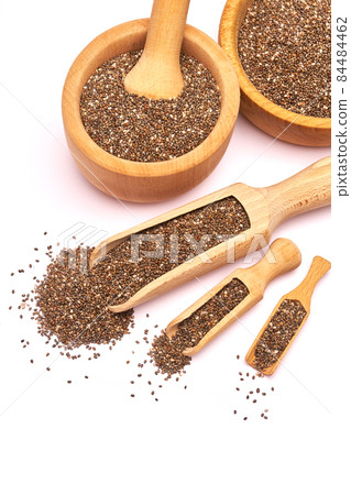 Wooden scoop of organic natural chia seeds close-up isolated on white background Wooden scoop of organic natural chia seeds close-up isolated on white background 84484462