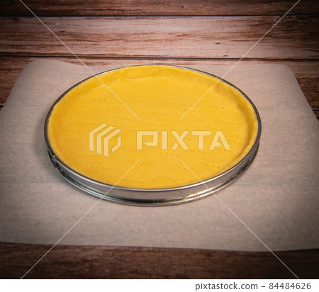 Metal fork makes holes in a raw pastry case in a metal baking tin Metal fork makes holes in a raw pastry case in a metal baking tin 84484626