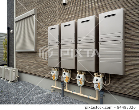 Gas water heaters lined up on the wall of the apartment 84485326