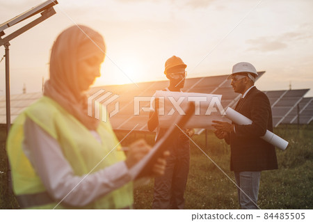 Multiracial people discussing project of solar station 84485505