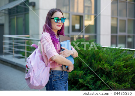 Portrait beautiful female writer dressed in casual outfit holding modern laptop in hand with backpack. Portrait beautiful female writer dressed in casual outfit holding modern laptop in hand with backpack. 84485550
