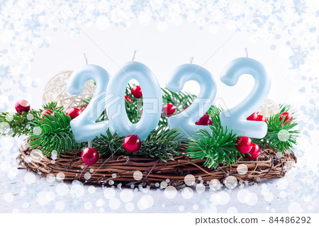New year composition with candle number 2022, pine branches, decorative balls, wreath, bokeh frame New year composition with candle number 2022, pine branches, decorative balls, wreath, bokeh frame 84486292