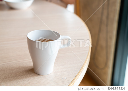 hot tea cup on table 84486884