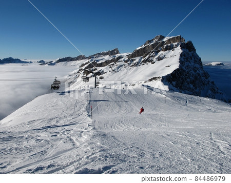 Ski slopes, mountain and sea of fog, Titlis ski area 84486979