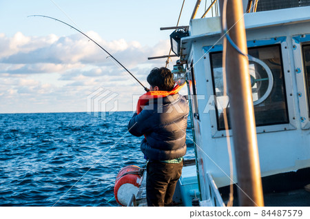People fishing in the sea 84487579