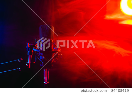 Professional microphone in red smoke on a black background. Professional microphone in red smoke on a black background. 84488419