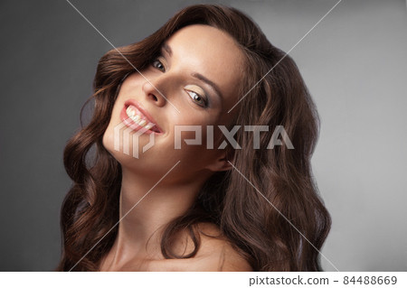 beautiful young woman having a happy thought 84488669