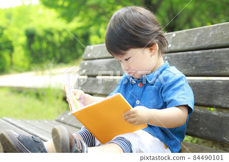 Boy reading a book Boy reading a book 84490101